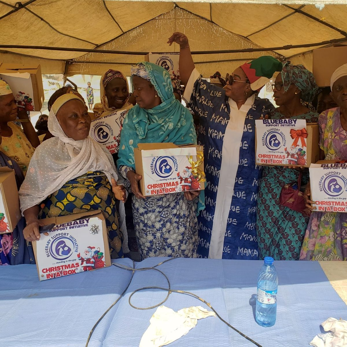 Beneficiaries holding Christmas In A Box gifts