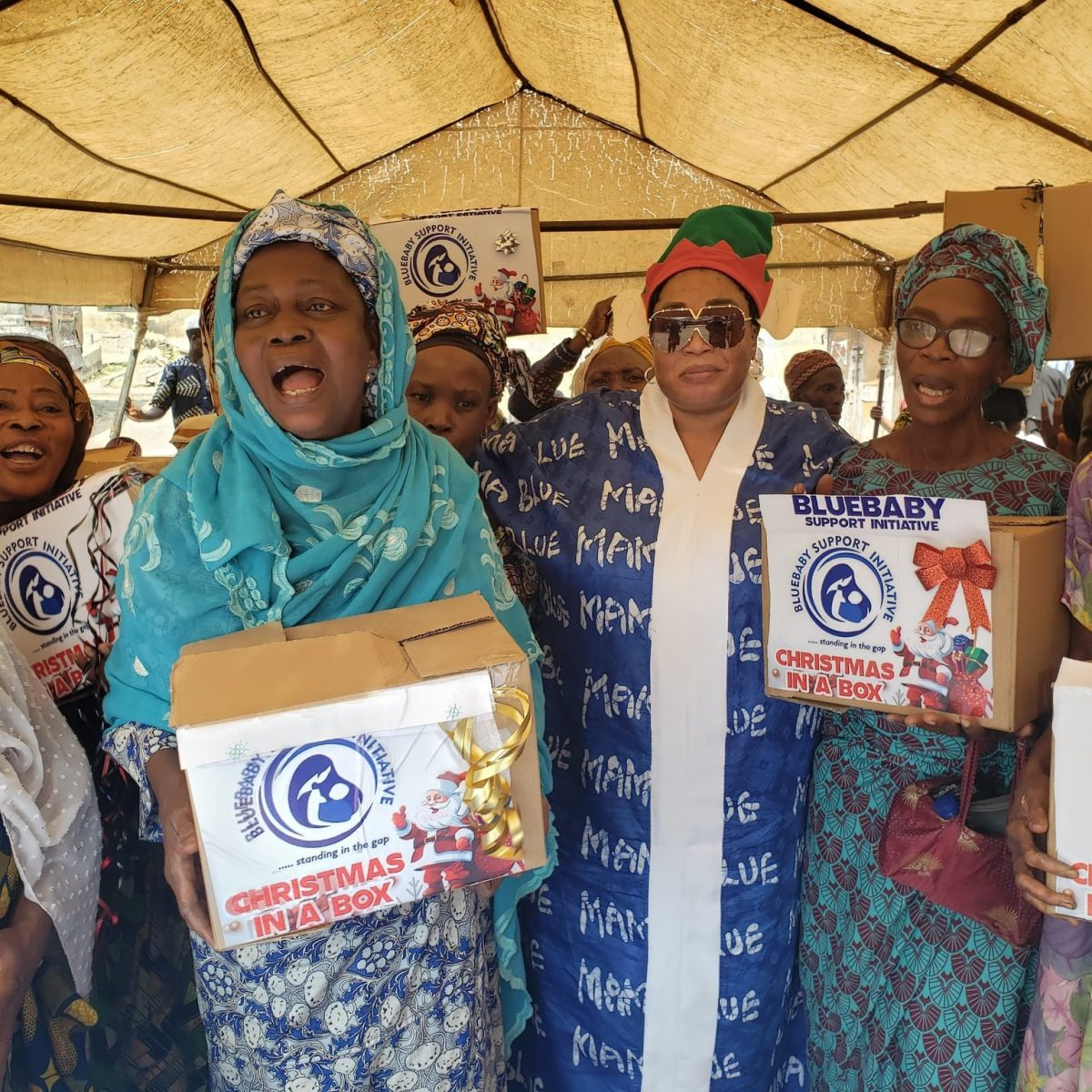 Beneficiaries celebrating with their Christmas In A Box gifts