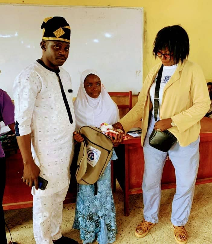 A student receiving her backpack from BBSI volunteers