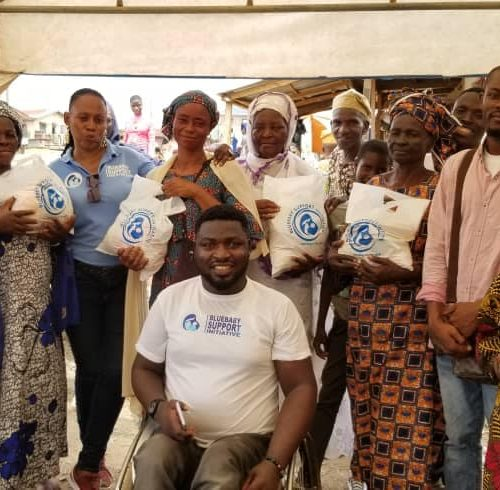 Women receiving relief packages during a BBSI community outreach